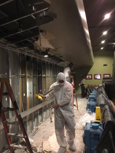 Commercial mold remediation in Las Vegas: full containment setup with air scrubbers and material removal in progress, Mold Eliminators